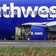 Emergency personnel monitor the damaged engine of Southwest Airlines Flight 1380, which diverted to the Philadelphia International Airport this morning, in Philadelphia, Pennsylvania